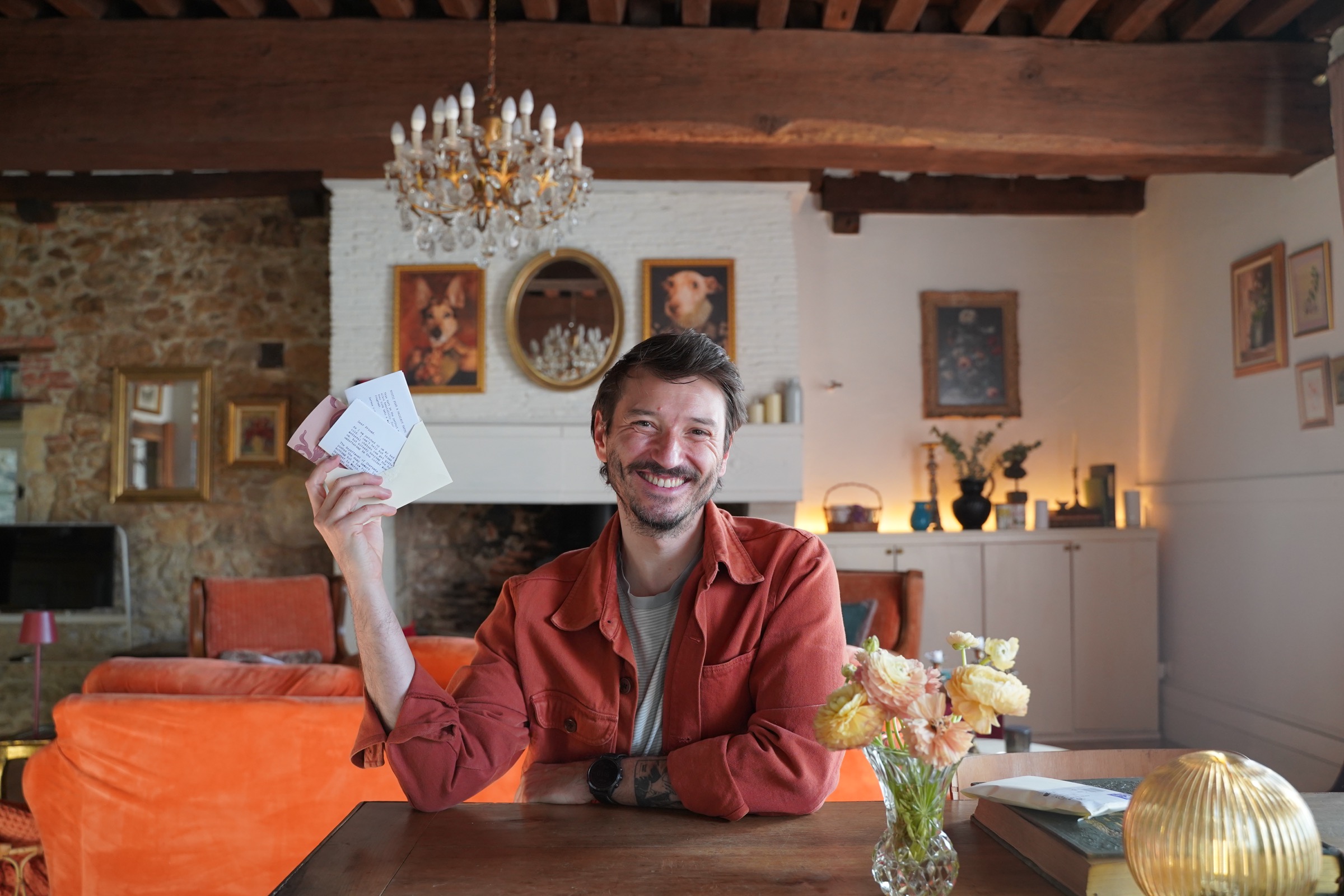 Amadeus smiling at the château while holding a Château Letter